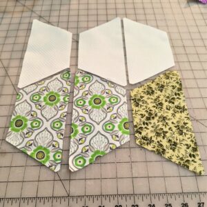 Shows half hexies and how to sew them together in rows.