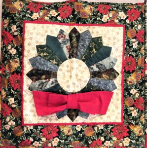 Quilted wall hanging of a Christmas wreath