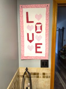 Valentines Day quilted banner that says love.