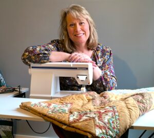 jeri ann sitting at her sewing machine.