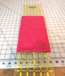 fabric folded around ruler