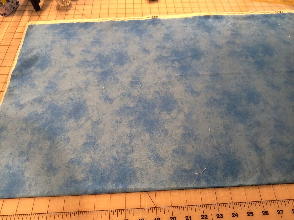 getting fabric ready to square up with the selvages together.