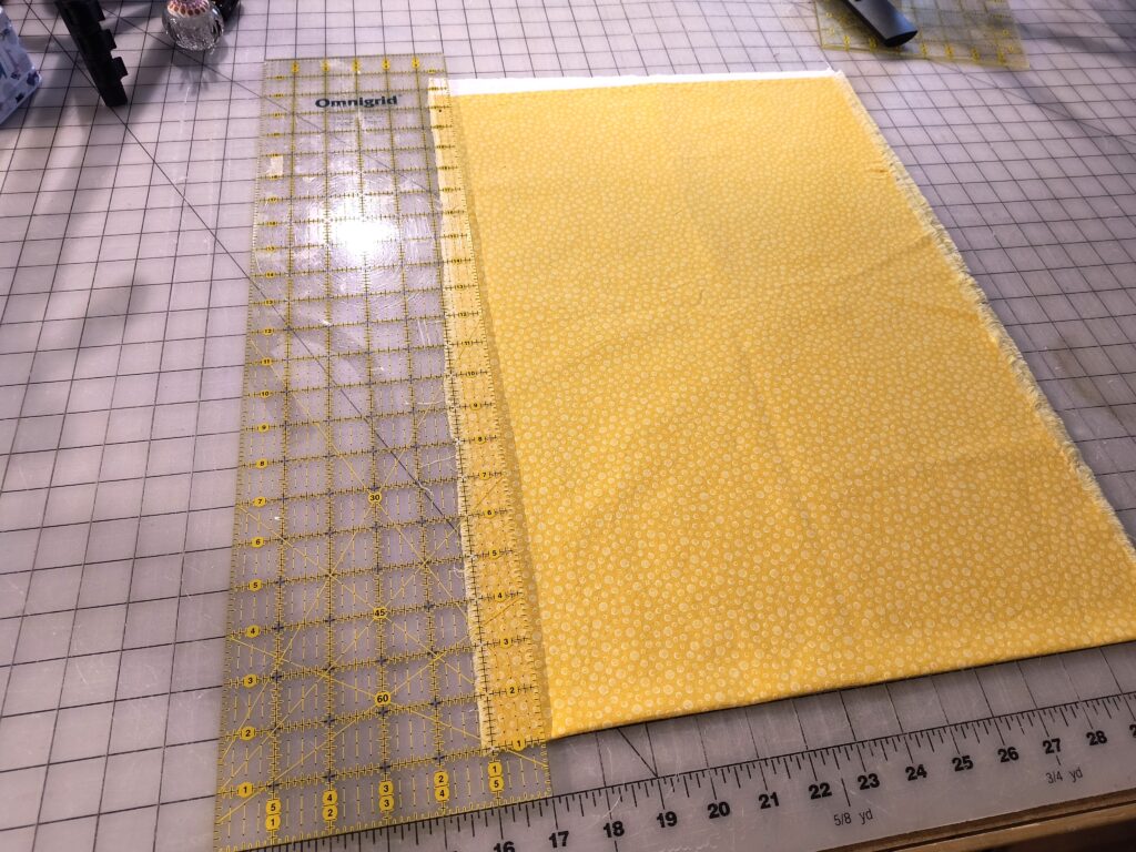 Lining ruler up to square up fabric.