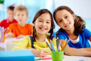 kids writing at a table